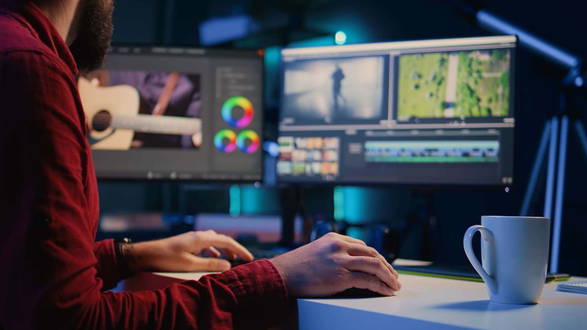 Video editing at a desk with two monitors: colour wheels on one, the timeline on the other.